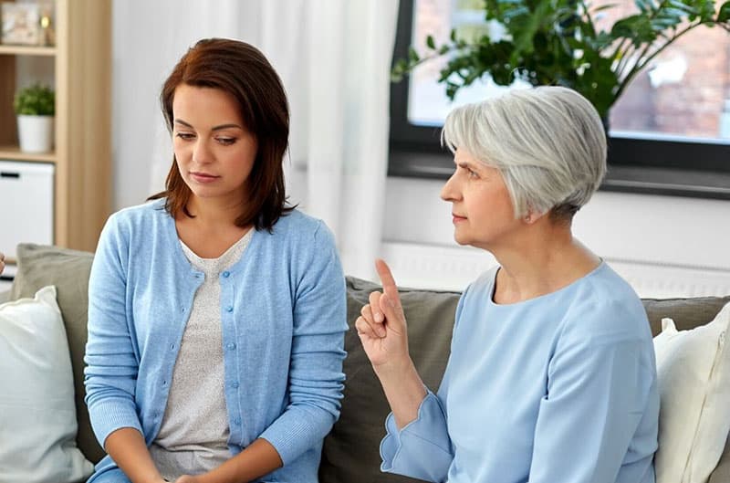 senior woman angry at a woman pointing her finger 