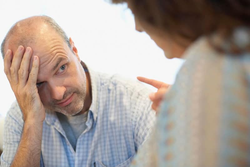 senior woman blaming husband pointing her finger to him