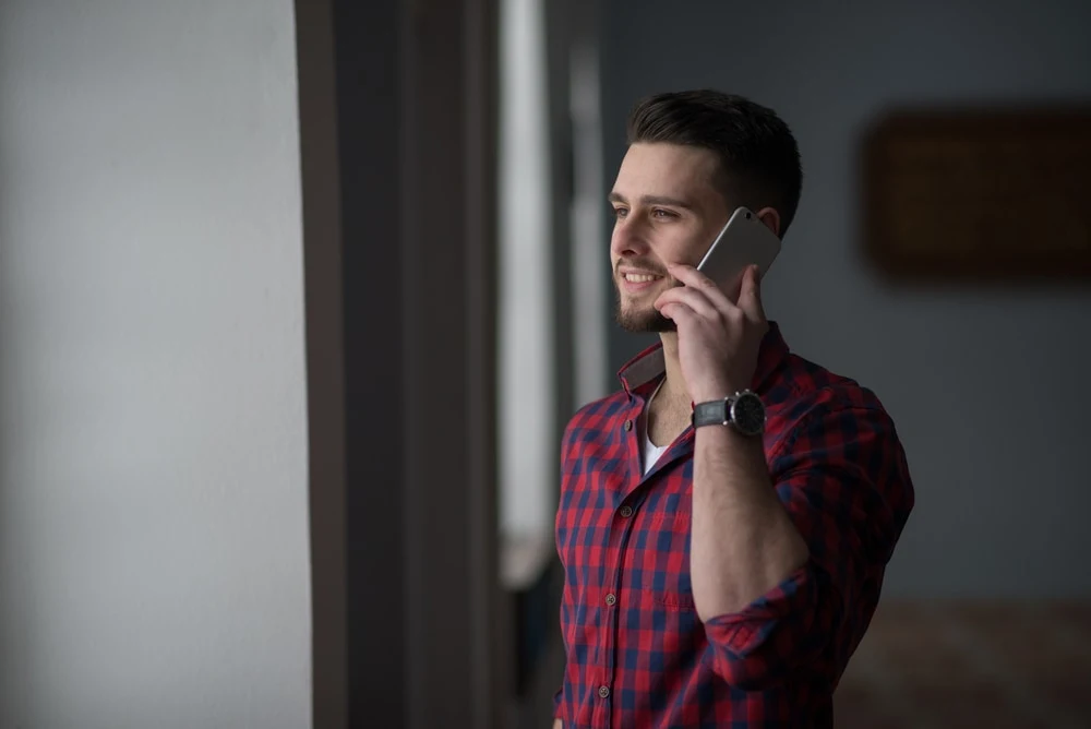 the man stands and talks on the phone