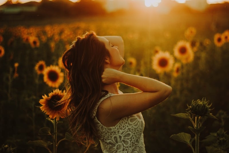woman standing near sunflower field during daytime