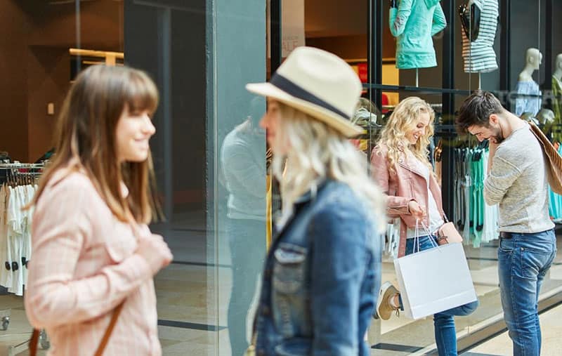 young people talking outside of a shopping mall