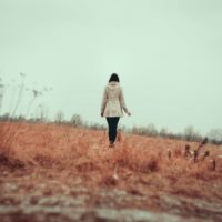 Young girl walking on grass field