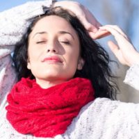 young woman with red knitted scarf outdoors