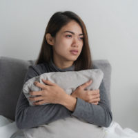 worried woman sitting and looking at distance