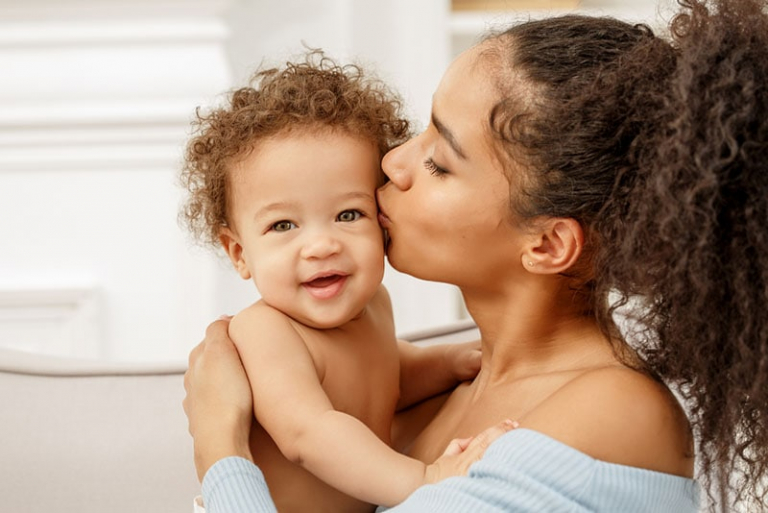 young mom kissing baby