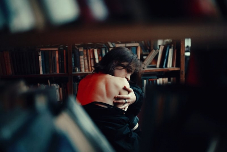 sad woman sitting inside the library