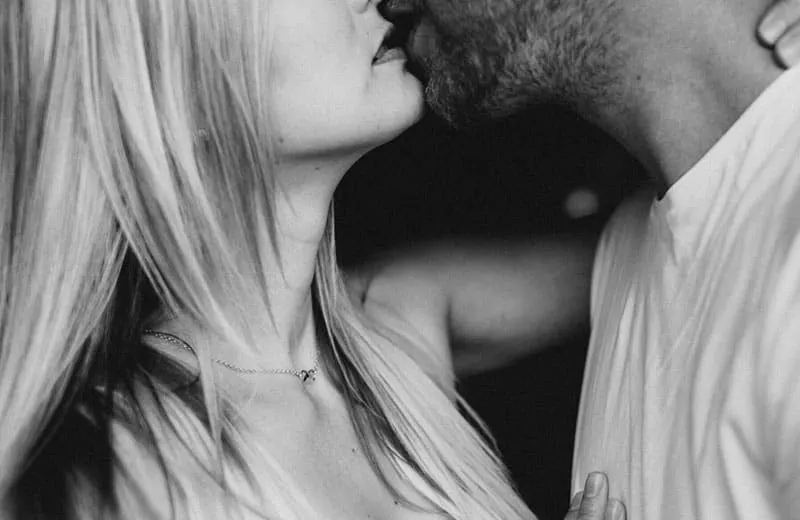 black and white photo of couple kissing on focus on the lower part of their faces