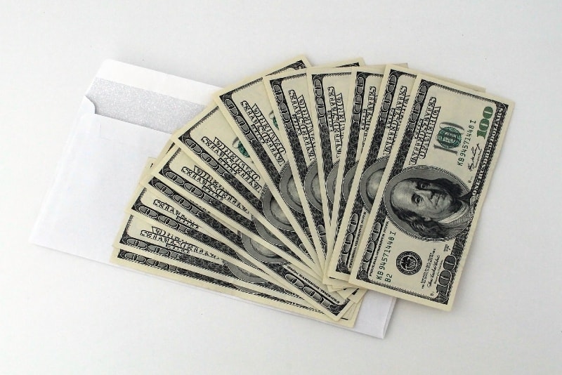 dollar banknotes on white envelope