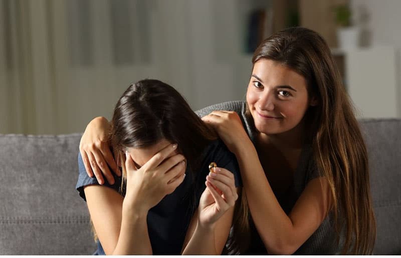 hypocrite friend comforting a divorced woman crying 