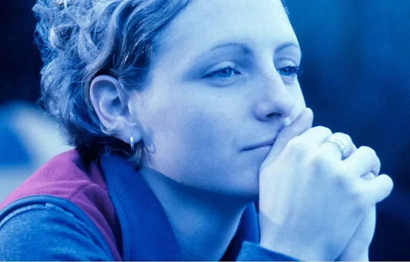 pensive woman in focus in blue themed photography