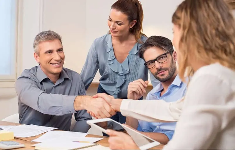 people doing handshake after a done deal over business meeting