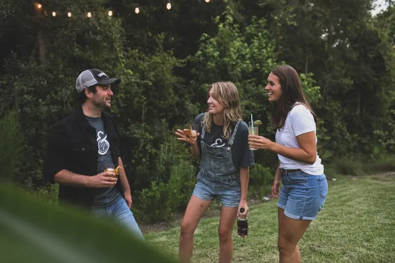 three people drinking alcohol outdoor