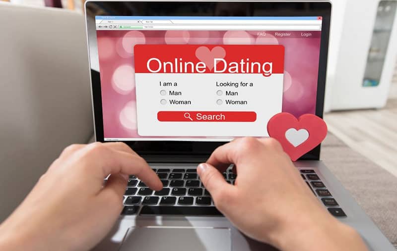 person using laptop for online dating app