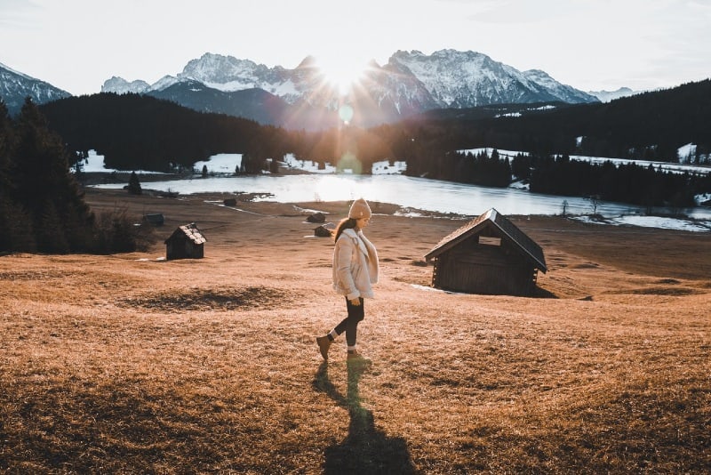 woman in brown coat standing in the field