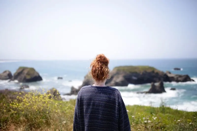 woman in printed sweater looking at water