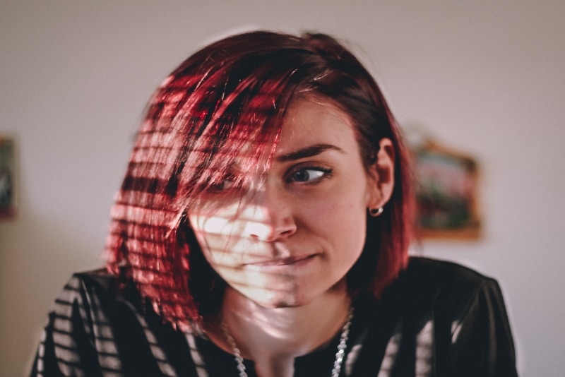 woman with red hair sitting indoor