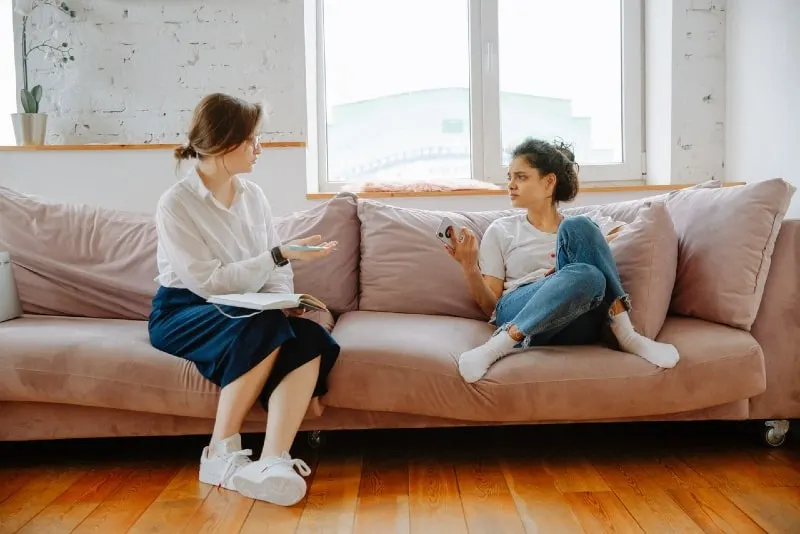 woman talking to therapist while sitting on sofa