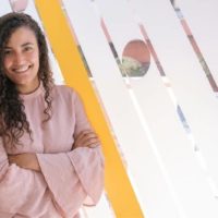 girl boss with arms crossed standing inside the office