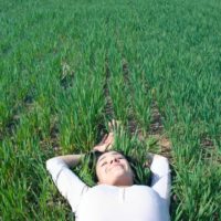 smiling woman lying on grass