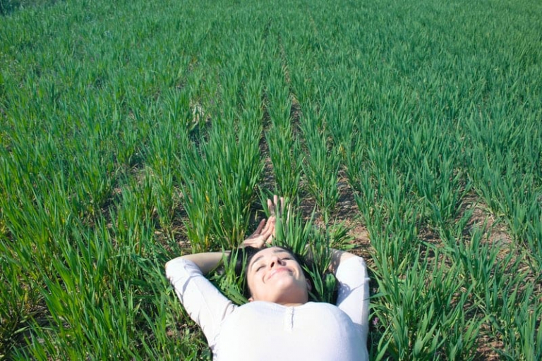 smiling woman lying on grass