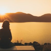 silhouette of a woman sitting alone in a concept of loneliness