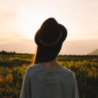 woman with hat looking at field