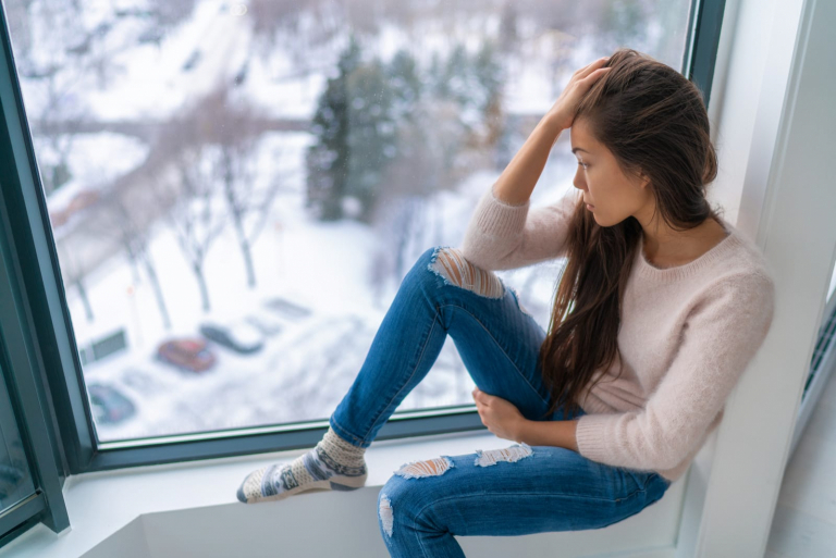 a woman sitting by the window