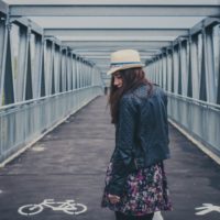 girl walking away on a bridge