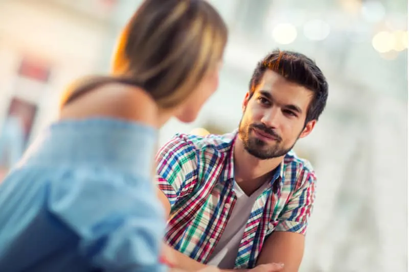 a man listening to the woman talking while sitting