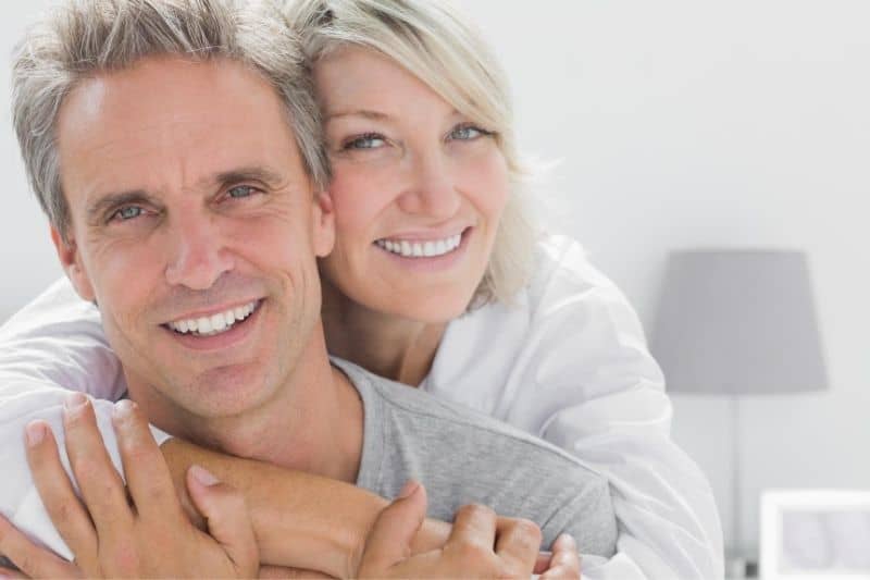 affectionate adult couple hugging inside living room