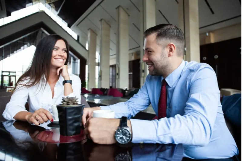 business people talking flirting inside a cafe