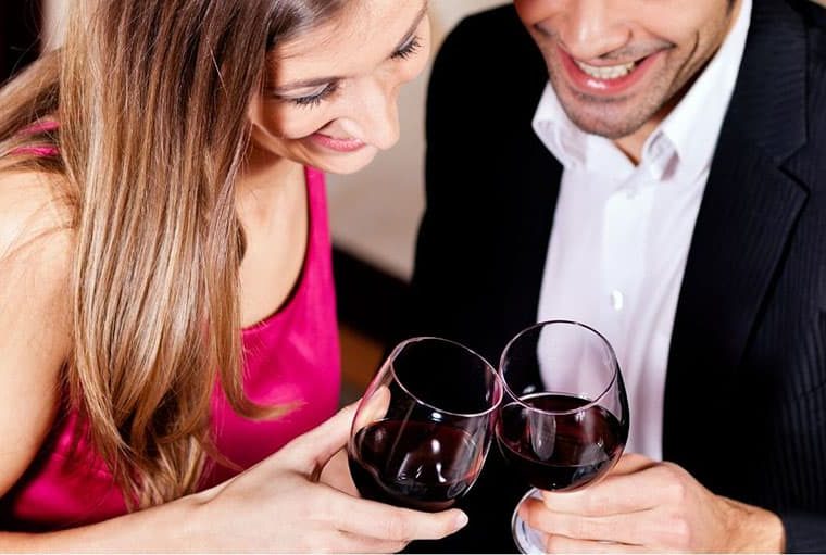 couple clinking wine glass during a date night in upper angle
