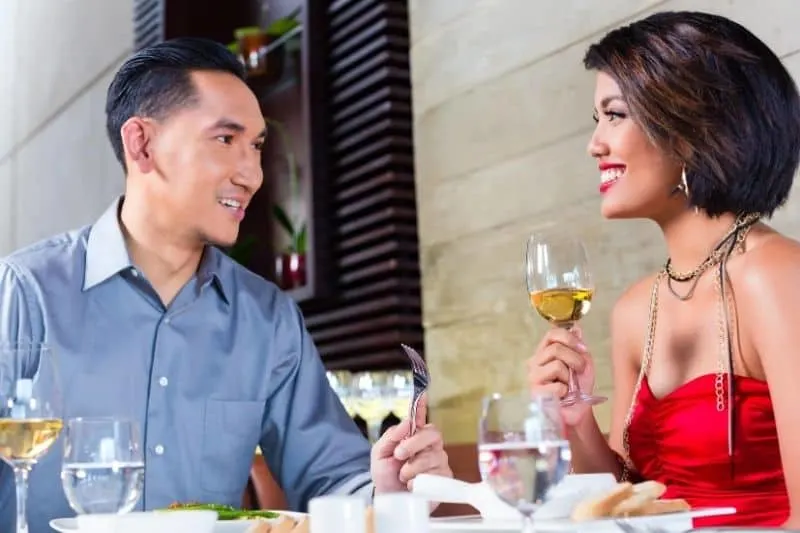 couple fine dining with wine and good food in a restaurant