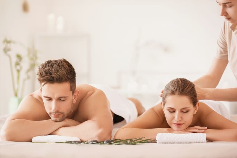 man and woman having massage during daytime