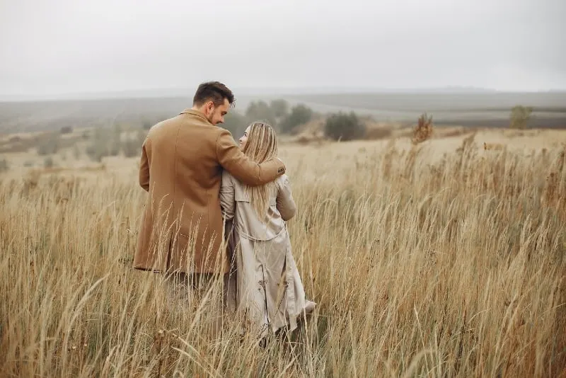 man and woman hugging in dry field