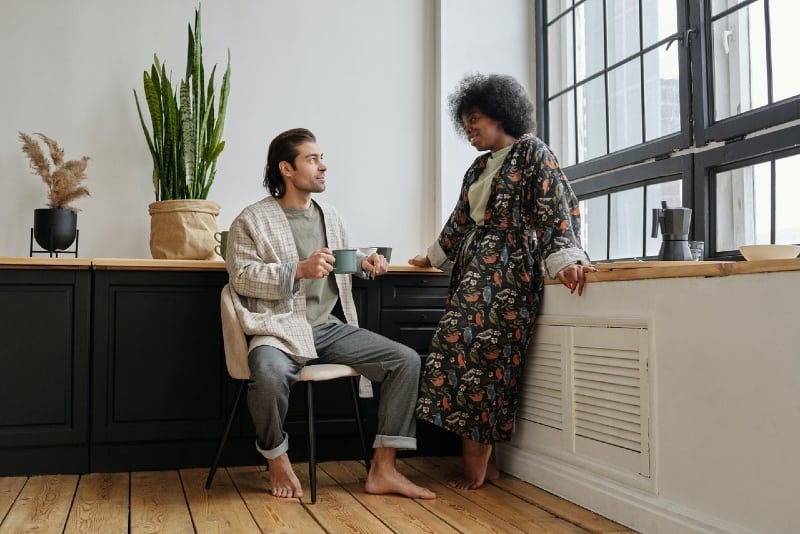 man with blue mug and woman making eye contact