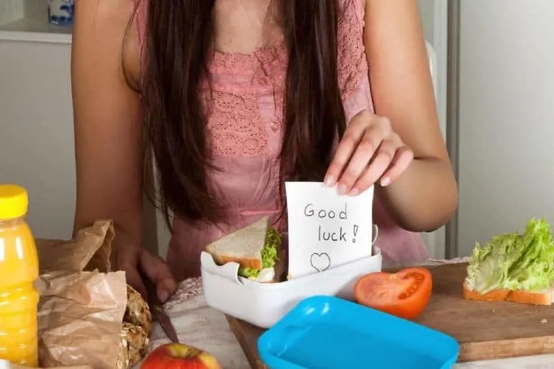 goodluck notes in lunchbox placed by the woman inside the kitchen