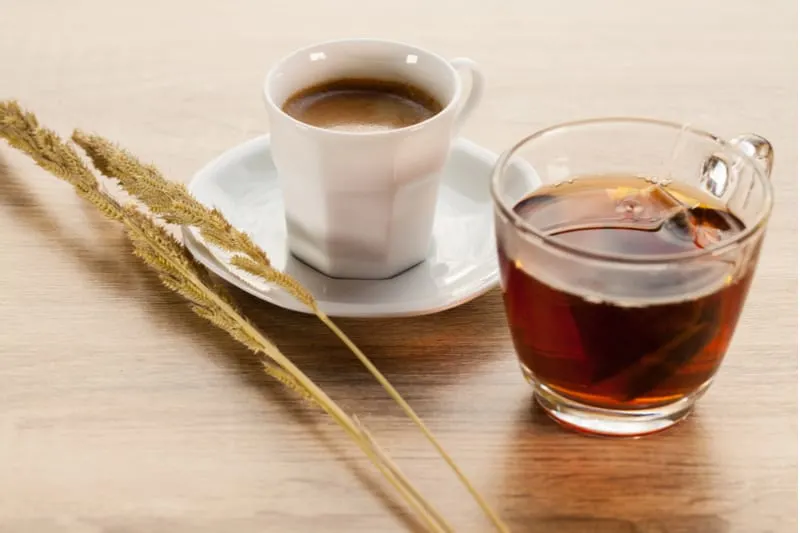 hot tea and coffee on wooden table with plant