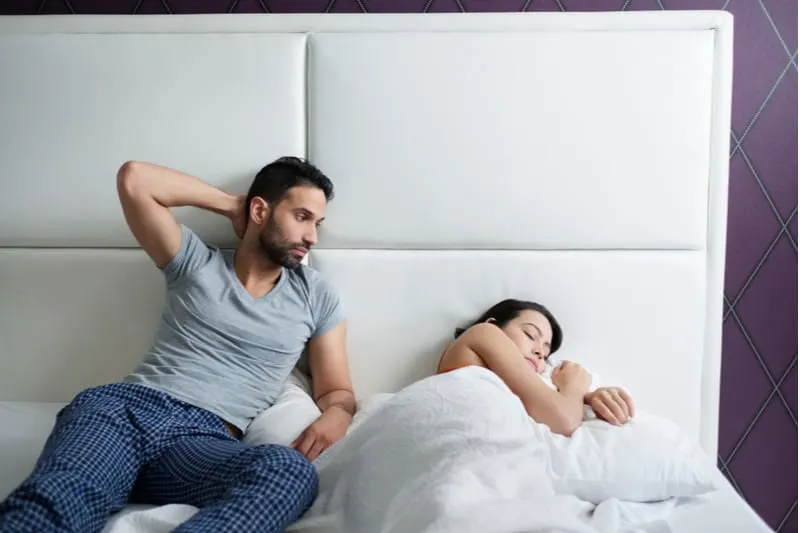 husband trying sexual approach to the bored wife in bed