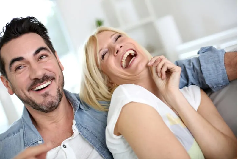love couple relaxing and chilling out sitting on sofa inside living room