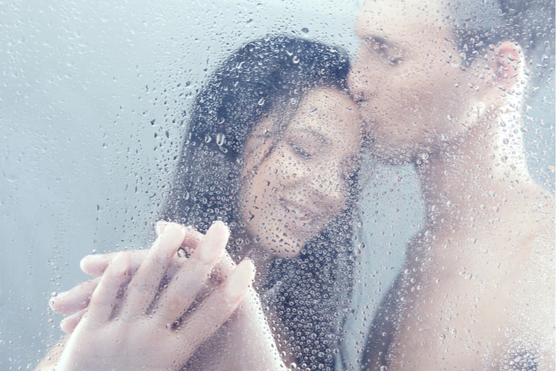 loving couple shower together man kissing woman on forehead