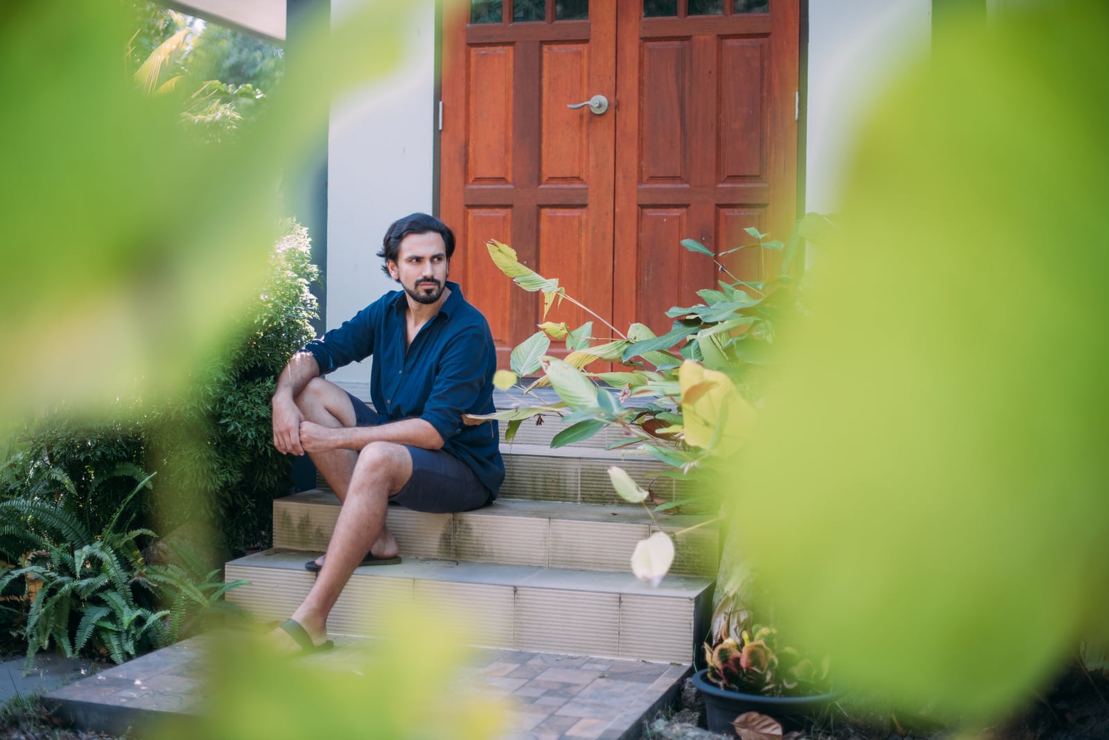 man sits on the porch of a house 