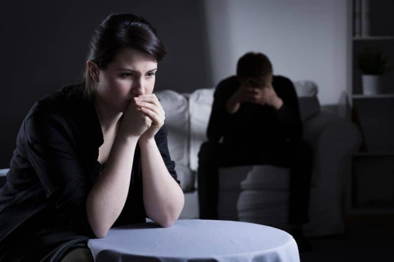 silent young couple sitting and hiding their emotions