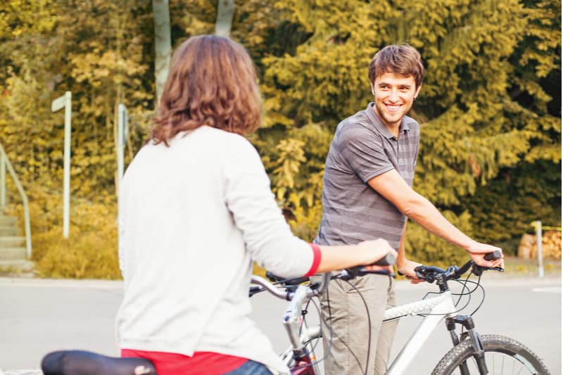 two people with common hobby of biking meet in the park