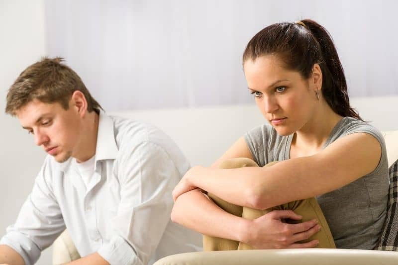 unhappy couple sitting silently after an argument