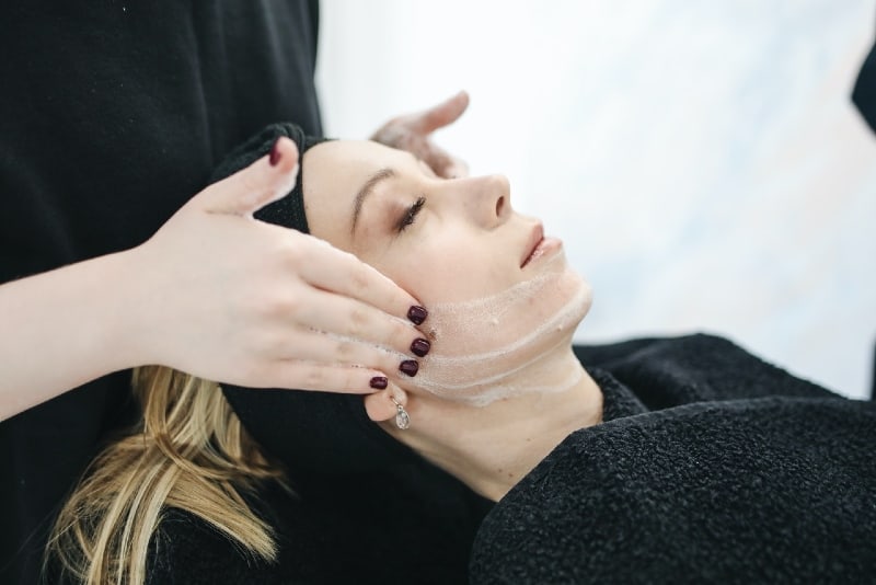 woman having facial care in spa