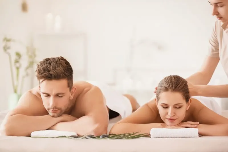 woman having massage while lying near man