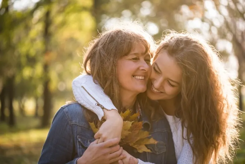 woman hugging woman while standing outdoor