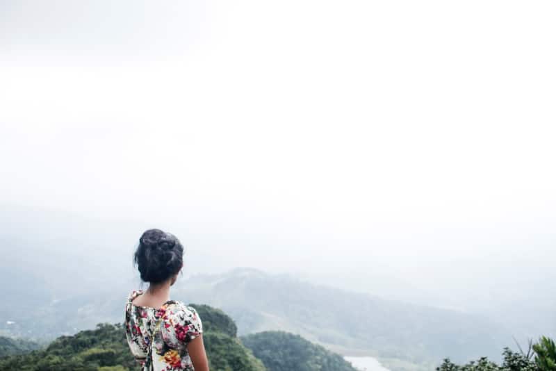 woman in floral top looking at mountain
