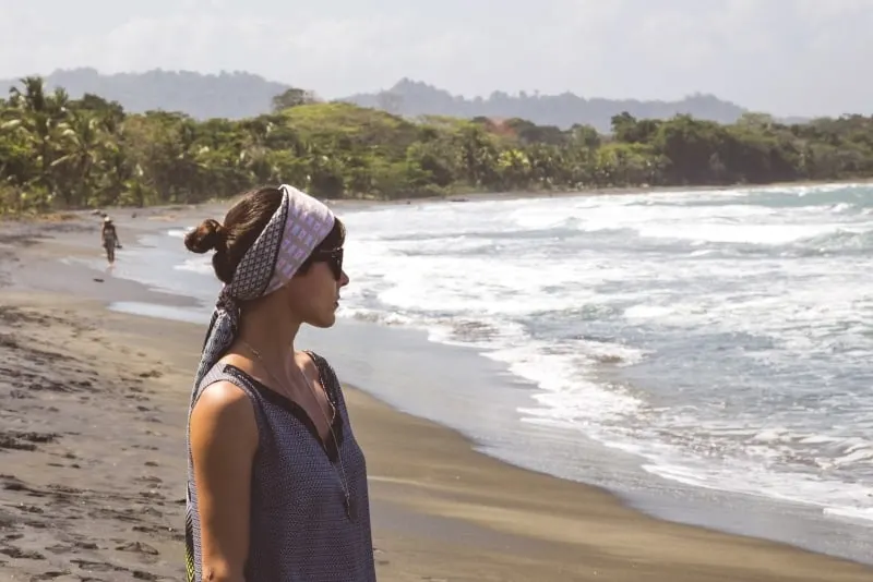 woman with head scarf looking at ocean